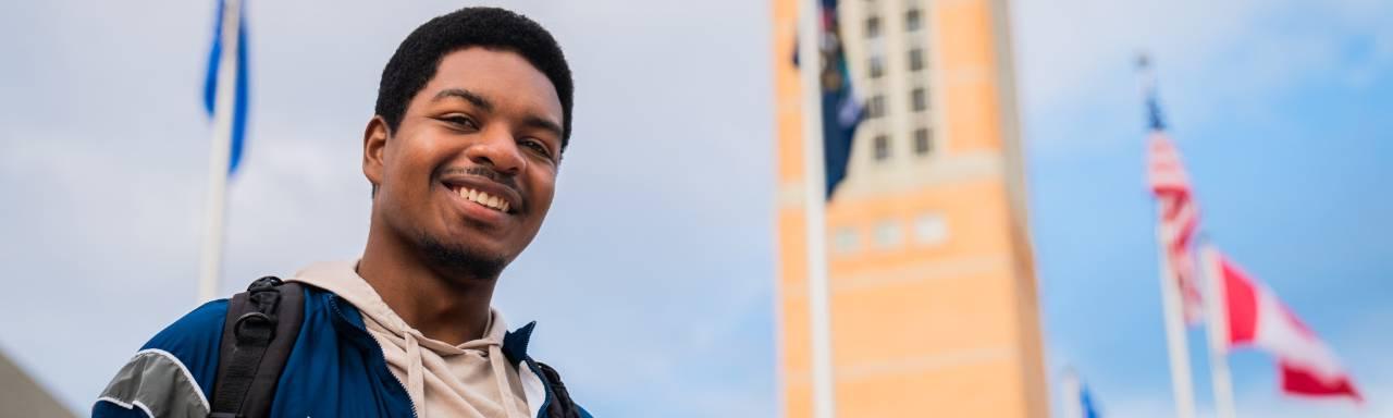 A GVSU veteran student in front of the clocktower.